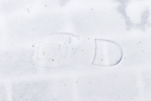 Boot track on thin first snow in winter. photo