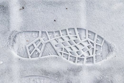 Boot track on thin first snow in winter. photo