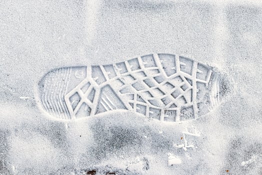 Boot track on thin first snow in winter. photo