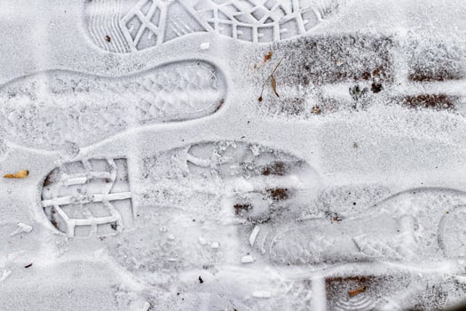 Boot track on thin first snow in winter. photo