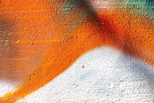 A fragment of colorful graffiti painted on a wall. Abstract urban background. photo