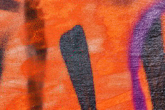 A fragment of colorful graffiti painted on a wall. Abstract urban background. photo