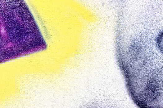 A fragment of colorful graffiti painted on a wall. Abstract urban background. photo