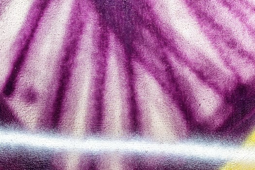 A fragment of colorful graffiti painted on a wall. Abstract urban background. photo