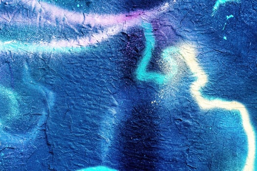 A fragment of colorful graffiti painted on a wall. Abstract urban background. photo