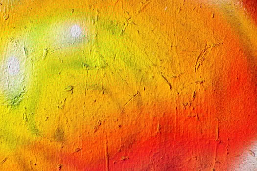 A fragment of colorful graffiti painted on a wall. Abstract urban background. photo