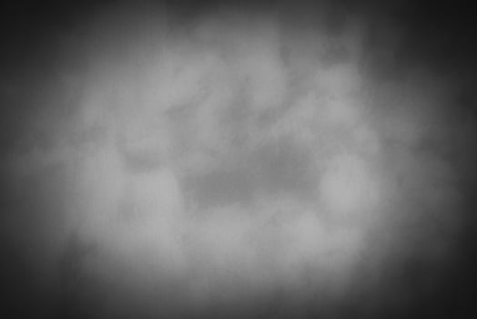 Blured gray decorative plaster or concrete background with vignette. photo