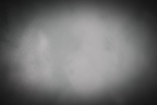 Blured gray decorative plaster or concrete background with vignette. photo