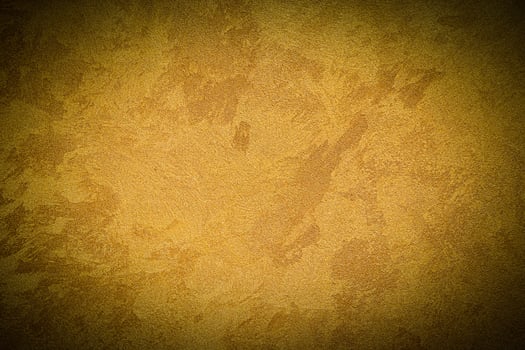 Texture of golden decorative plaster or concrete with vignette. photo