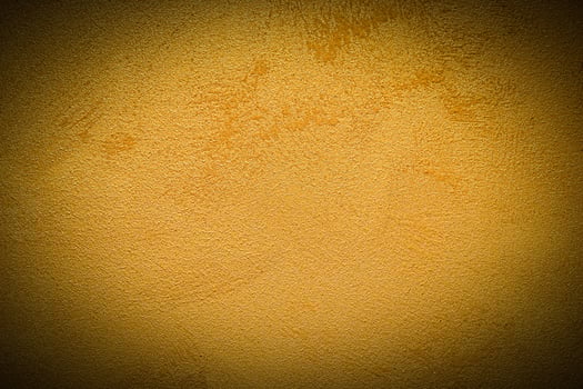 Texture of golden decorative plaster or concrete with vignette. photo
