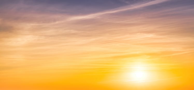 Colorful dramatic clouds lit by a sun against the sunset or sunrise sky. photo