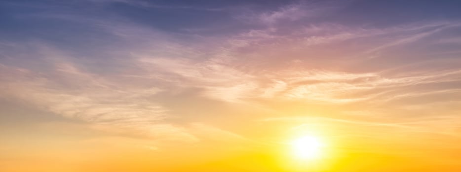 Colorful dramatic clouds lit by a sun against the sunset or sunrise sky. photo