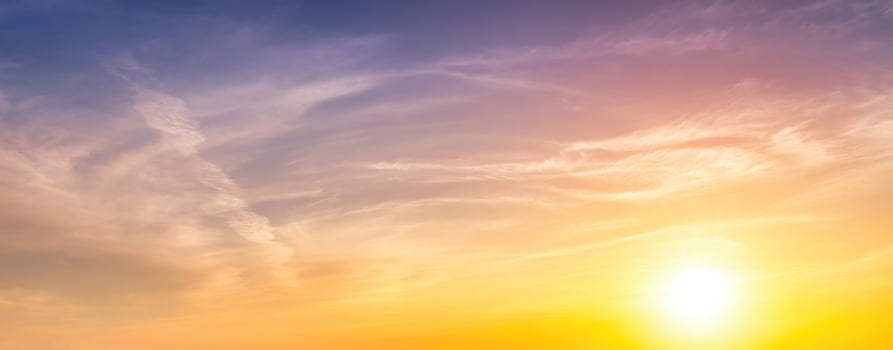 Colorful dramatic clouds lit by a sun against the sunset or sunrise sky. photo