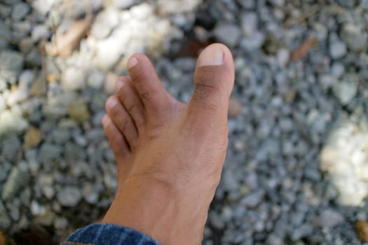 a man legs in dark brown. Asian man. gravel background photo