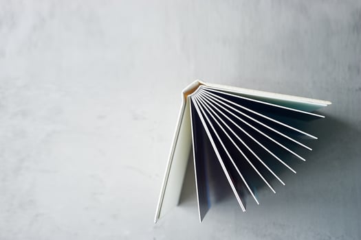 Photobook in hard leather cover on a gray concrete background. Making photos and storing them.A wedding album or book in an expensive binding.