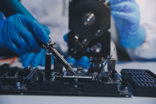 Close up of Technician measuring voltage electronic circuit board television, Service after sale fix electric equipment within insurance. photo