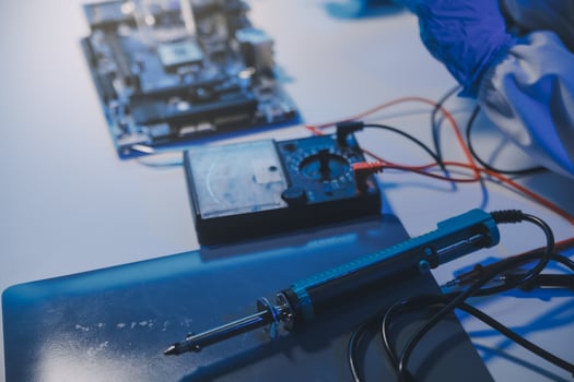 Close up of Technician measuring voltage electronic circuit board television, Service after sale fix electric equipment within insurance. photo