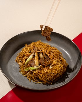 Mi Goreng is a noodle dish cooked in a typical Indonesian stir-fry with pieces of beef photo