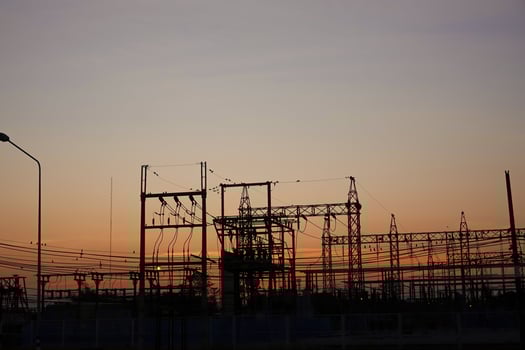 Silhouetted high-voltage electric tower in the dramatic sunset sky photo