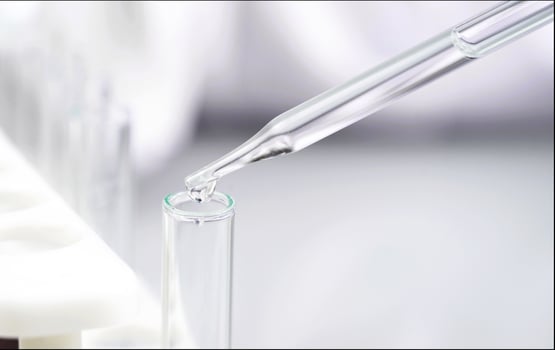 Scientist holding test tube in science lap photo