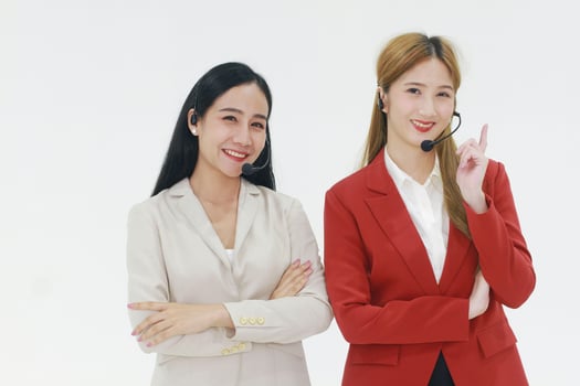 Smiling couple businesswoman Call Center meeting with Colleague for Technical Support staff or receptionist phone operator teamwork. Asian customer support team. photo