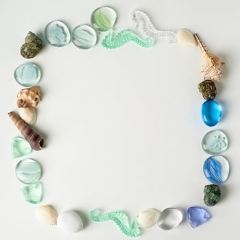 The layout of sea shells, the artwork from the sea.Little things to remember your vacation. The form of a square. An empty space in the middle. photo