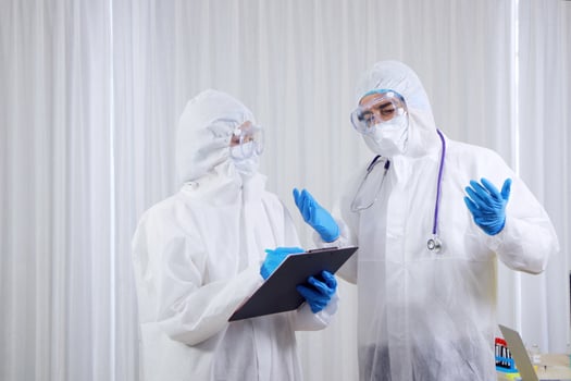 Medical team in Personal Protective Equipment or PPE clothing Researching and Discussing for patients infected with the Covid 19 virus and treatment in emergency and lab at hospital in Thailand photo