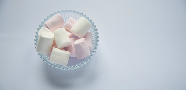 Fluffy white marshmallow macro isolated over white background. photo
