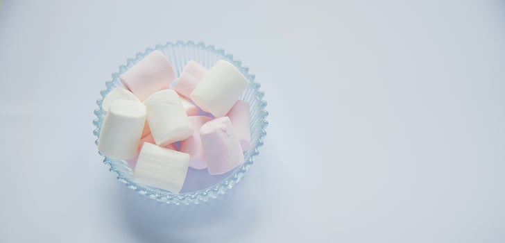 Fluffy white marshmallow macro isolated over white background. photo