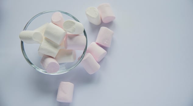 Fluffy white marshmallow macro isolated over white background. photo