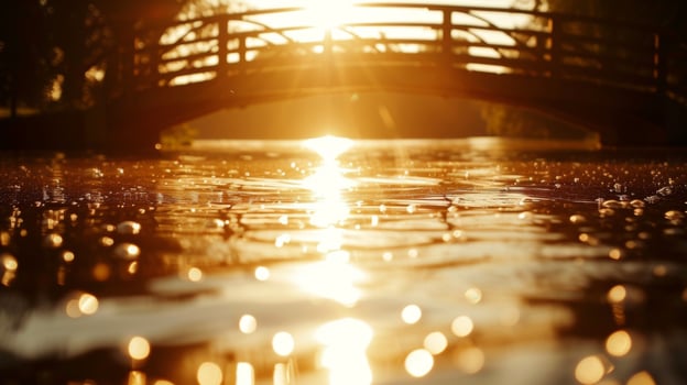 A river glitters with the reflection of a backlit bridge as the sun sets in the background creating a picturesque scene photo