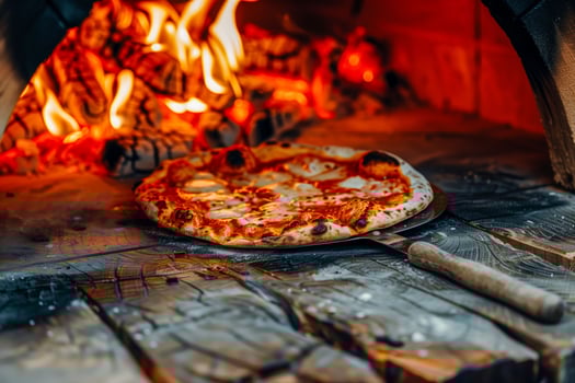 A pizza on a plate by a fireplace photo