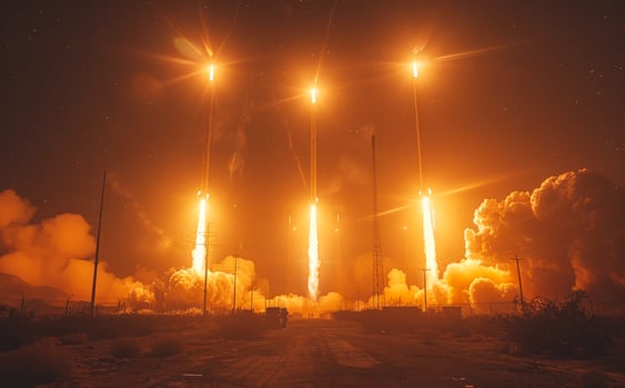 Rocket launch at night with orange flames and smoke photo