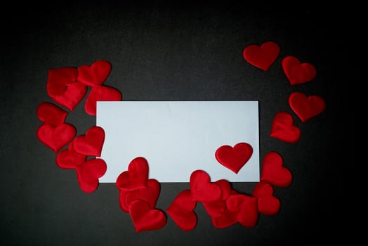 Valentine's day,a Declaration of love.White envelope with red hearts. Valentine. On a dark gray background. photo
