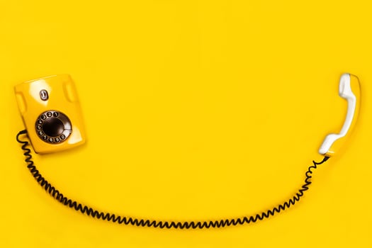 Yellow old stylish Phone, telephone with dial on yellow background copy space for your text flat lay photo