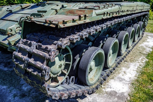 tracks and wheels of tank t80, armored vehicles on the street in green khaki color photo