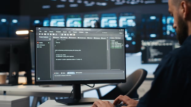 IT employee programming in server hub housing supercomputers storing datasets. Close up shot of expert typing code on computer to mend data center racks doing complex computational operations photo