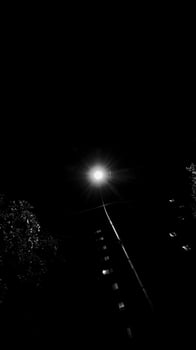 A single post light glowing in an extreme dark area photo