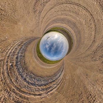 blue hole sphere little planet inside sand or dry grass round frame background photo