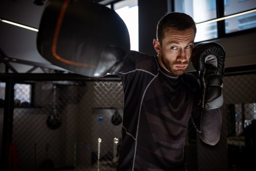 Determined athlete throwing powerful right hook during shadow fight photo