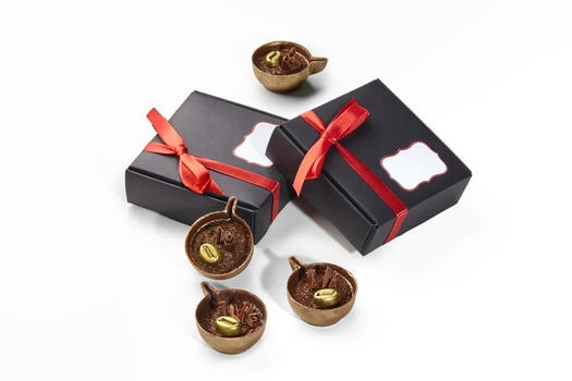 Chocolate candies in shape of miniature coffee cups in gift boxes photo