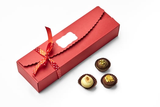 Artisan chocolate candies encased in elegant red gift box photo