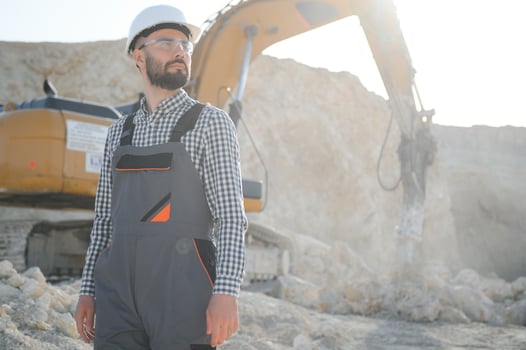 Male worker with bulldozer in sand quarry photo