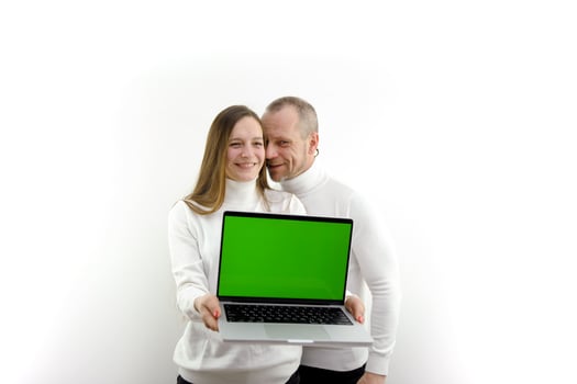 man and woman laptop with green screen chromakey happy satisfied advertises product online training man whispers something in ear online shopping white background place for text satisfied and happy photo