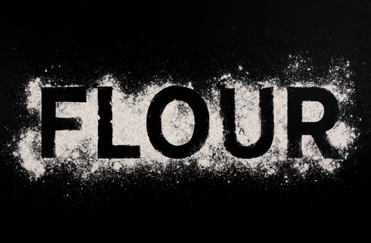 Word flour on dark table photo