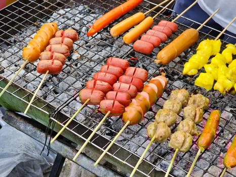 Sausage on skewers grilled over charcoal in Thai style. photo