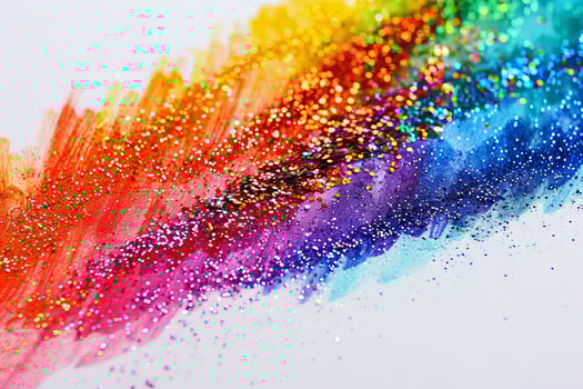 Rainbow-colored glitter transparently sprinkled on a handmade greeting card photo