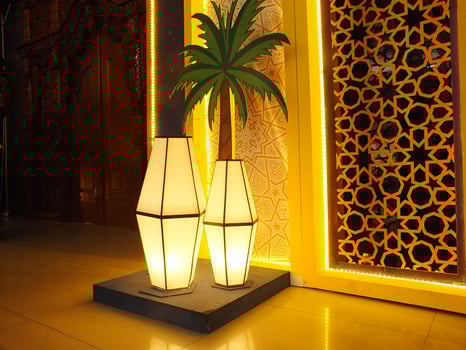 A scenic view of an interior home design, decorative lamp, palm tree and geometric pattern of Islamic culture. Arabic ambience of interior building photo
