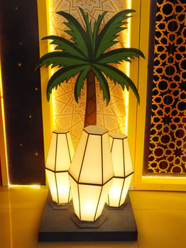 A scenic view of an interior home design, decorative lamp, palm tree and geometric pattern of Islamic culture. Arabic ambience of interior building photo