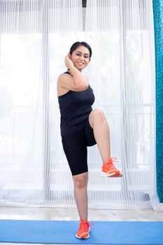 Woman In Black Doing Criss Cross Crunches Exercise photo